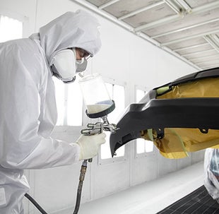 Collision Center Technician Painting a Vehicle | Lakeland Toyota in Lakeland FL