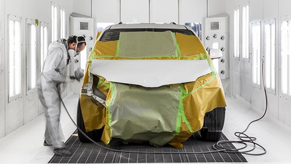 Collision Center Technician Painting a Vehicle | Lakeland Toyota in Lakeland FL